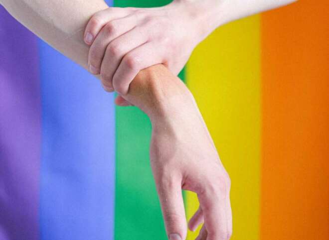 arms-in-front-of-a-gay-pride-flag-4611697